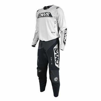 Motocross outfit with white top and black pants featuring 'CNVS' branding on a white background.
