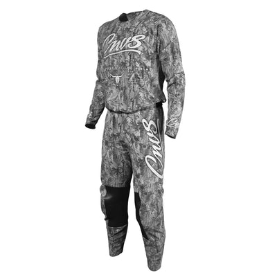 A long-sleeve motocross jersey and matching pants set in a gray and black camouflage pattern, featuring white 'Cnvs' script logos on the chest and thigh, with black knee panels, shown on a plain white background.
